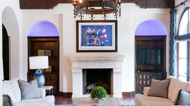 7519 Red Bay Cir, Magnolia, TX 77354 - living area featuring a chandelier, a fireplace, and arched walkways