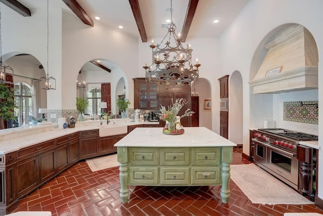 7519 Red Bay Cir, Magnolia, TX 77354 - kitchen featuring appliances with stainless steel finishes, a sink, custom exhaust hood, a center island, and beamed ceiling