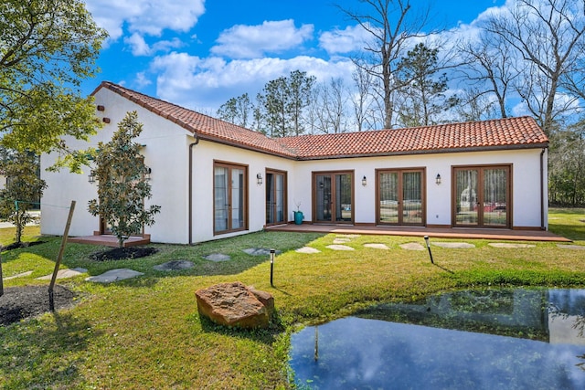 7519 Red Bay Cir, Magnolia, TX 77354 - rear view of house with french doors, a tiled roof, and a yard