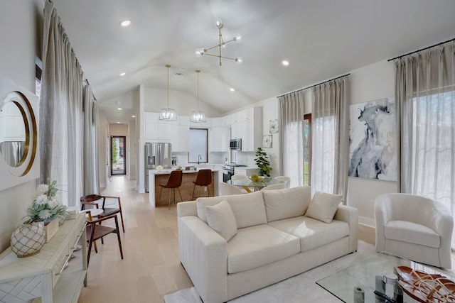 7519 Red Bay Cir, Magnolia, TX 77354 - living room featuring a chandelier, light wood-type flooring, recessed lighting, and high vaulted ceiling