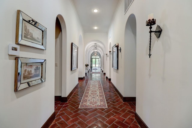 7519 Red Bay Cir, Magnolia, TX 77354 - hall with baseboards, brick flooring, arched walkways, recessed lighting, and crown molding