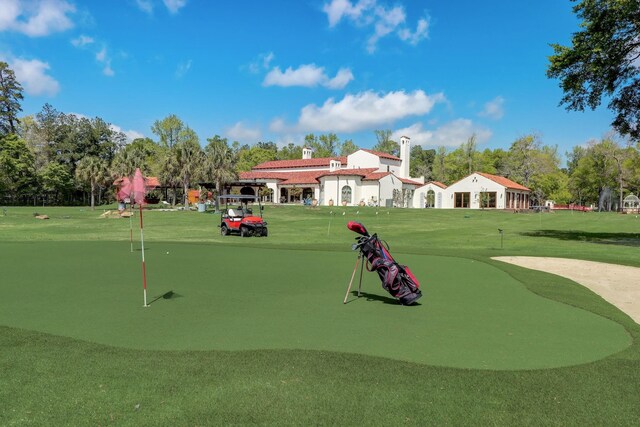 7519 Red Bay Cir, Magnolia, TX 77354 - view of community with a yard, a putting green, and view of golf course