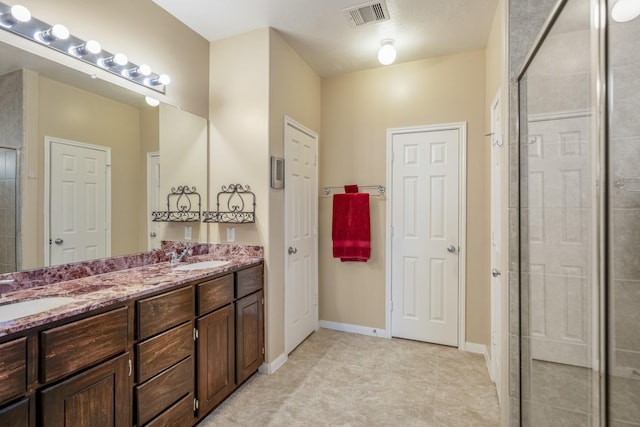 18720 Serenity Loch Dr, Spring, TX 77379 - bathroom featuring a shower stall, double vanity, and tile patterned floors