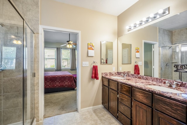 18720 Serenity Loch Dr, Spring, TX 77379 - ensuite bathroom featuring double vanity, a stall shower, tile patterned floors, and ceiling fan