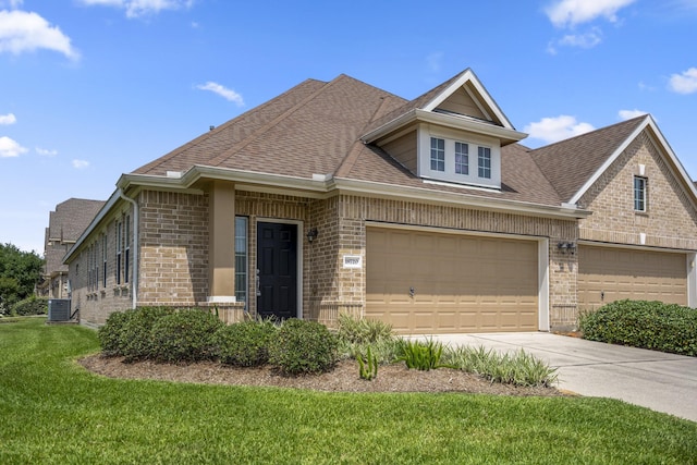 18720 Serenity Loch Dr, Spring, TX 77379 - view of front of home with brick siding, cooling unit, roof with shingles, and a front lawn