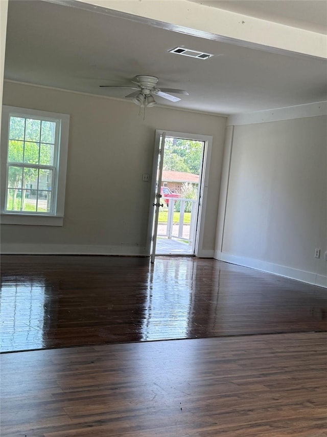 111 Conroe Dr, Conroe, TX 77301 - empty room with plenty of natural light, wood finished floors, and baseboards