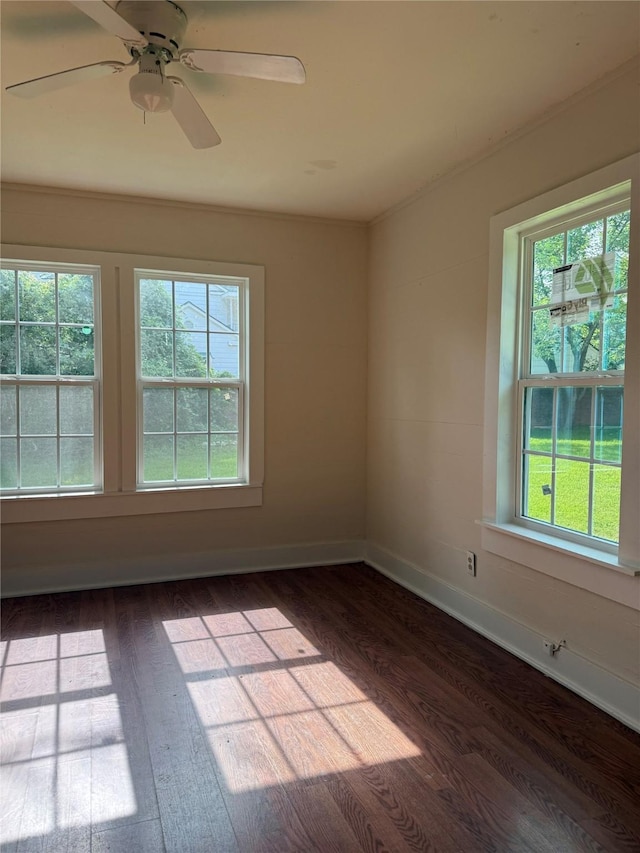111 Conroe Dr, Conroe, TX 77301 - empty room with dark wood-style flooring, plenty of natural light, baseboards, and a ceiling fan