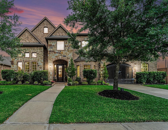21806 W Firemist Ct, Cypress, TX 77433 - french country home with a front lawn and stone siding