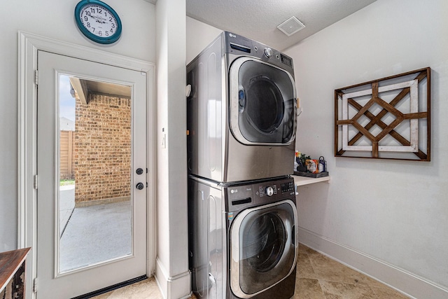 21806 W Firemist Ct, Cypress, TX 77433 - laundry area featuring stacked washer and clothes dryer and baseboards
