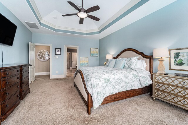 21806 W Firemist Ct, Cypress, TX 77433 - bedroom featuring light carpet, a tray ceiling, baseboards, and ceiling fan
