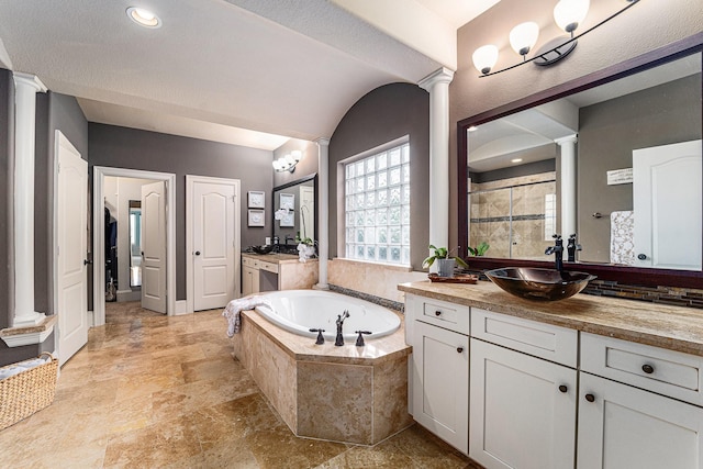 21806 W Firemist Ct, Cypress, TX 77433 - full bathroom with decorative columns, a bath, two vanities, and stone finish floors