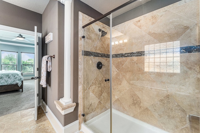 21806 W Firemist Ct, Cypress, TX 77433 - ensuite bathroom featuring tiled shower, ceiling fan, ornate columns, and baseboards