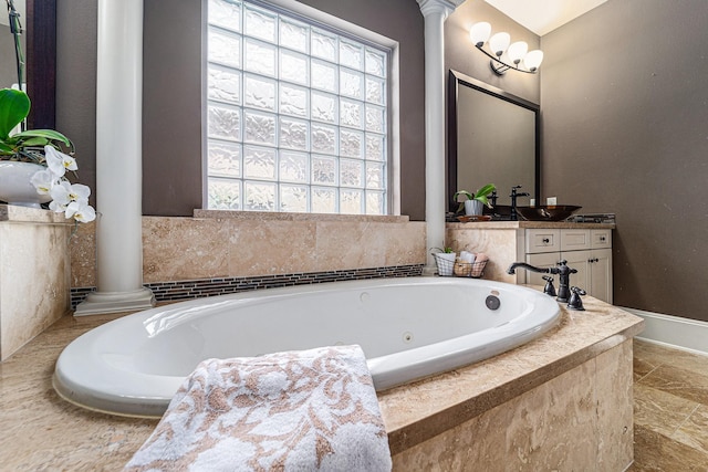 21806 W Firemist Ct, Cypress, TX 77433 - bathroom featuring decorative columns, a whirlpool tub, vanity, and baseboards