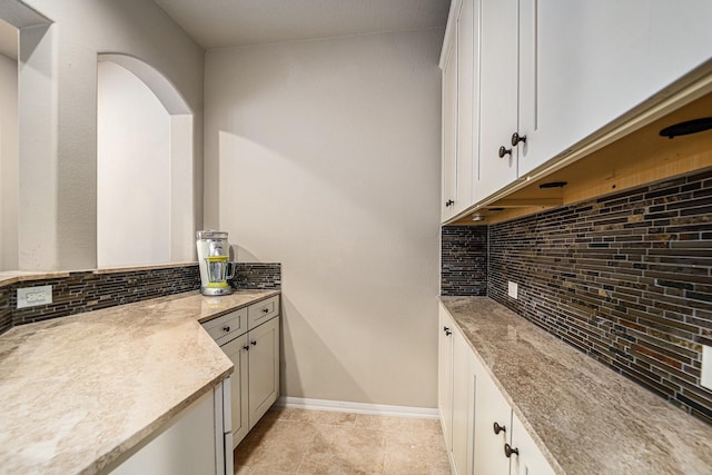 21806 W Firemist Ct, Cypress, TX 77433 - kitchen with decorative backsplash, white cabinets, baseboards, and light tile patterned floors