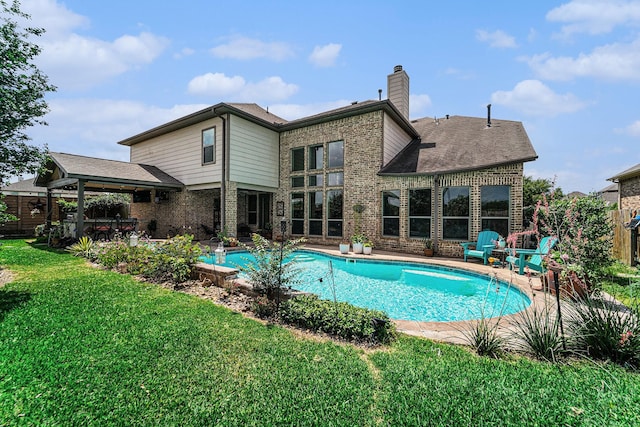21806 W Firemist Ct, Cypress, TX 77433 - rear view of house featuring brick siding, a patio area, and a chimney