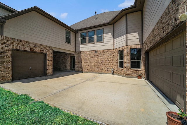 21806 W Firemist Ct, Cypress, TX 77433 - view of property exterior with brick siding, driveway, and an attached garage