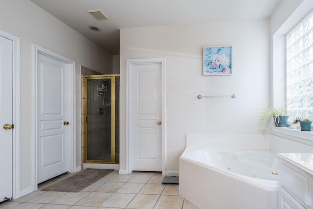 11510 Maple Falls Dr, Tomball, TX 77377 - full bathroom with a tub with jets, a shower stall, tile patterned flooring, and baseboards