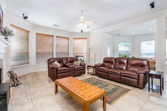 11510 Maple Falls Dr, Tomball, TX 77377 - living room with a fireplace, light tile patterned floors, a ceiling fan, crown molding, and baseboards