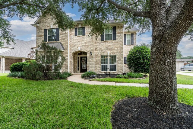 11510 Maple Falls Dr, Tomball, TX 77377 - view of front facade with brick siding and a front yard