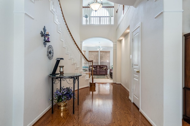 11510 Maple Falls Dr, Tomball, TX 77377 - entryway featuring plenty of natural light, wood finished floors, stairway, arched walkways, and a high ceiling