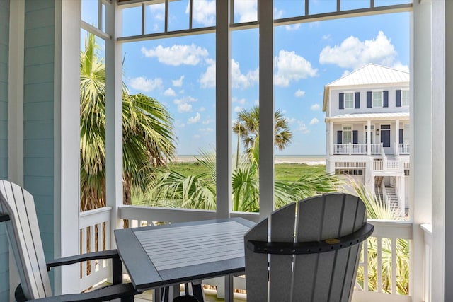 1822 Seaside Dr, Galveston, TX 77550 - sunroom / solarium with a water view and healthy amount of natural light