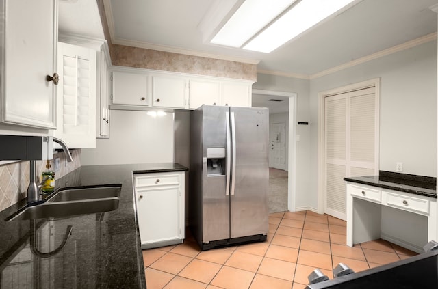 108 Hereford Dr, Conroe, TX 77304 - kitchen with stainless steel fridge with ice dispenser, white cabinets, a sink, light tile patterned flooring, and tasteful backsplash