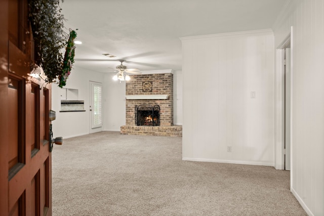 108 Hereford Dr, Conroe, TX 77304 - unfurnished living room with carpet, ceiling fan, a brick fireplace, baseboards, and crown molding