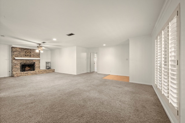 108 Hereford Dr, Conroe, TX 77304 - unfurnished living room with ceiling fan, carpet, a brick fireplace, baseboards, and recessed lighting