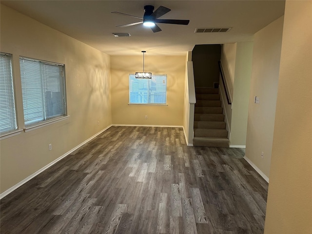 6410 Provident Green Dr, Katy, TX 77449 - unfurnished living room with a ceiling fan, dark wood-style floors, stairs, baseboards, and arched walkways