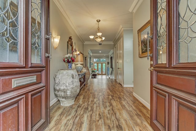 8800 Woodway Dr Unit 12, Houston, TX 77063 - entrance foyer with a chandelier, baseboards, light wood finished floors, and ornamental molding