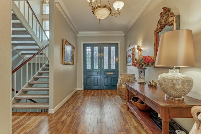 8800 Woodway Dr Unit 12, Houston, TX 77063 - entrance foyer featuring stairway, hardwood / wood-style floors, ornamental molding, a chandelier, and baseboards