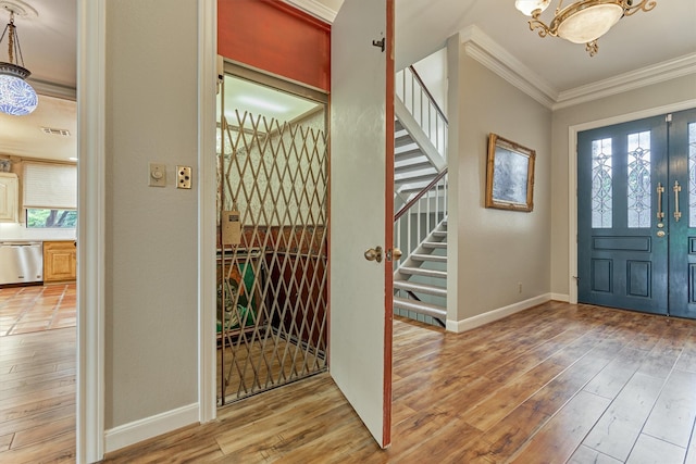 8800 Woodway Dr Unit 12, Houston, TX 77063 - entryway with ornamental molding, a chandelier, light wood finished floors, stairs, and baseboards