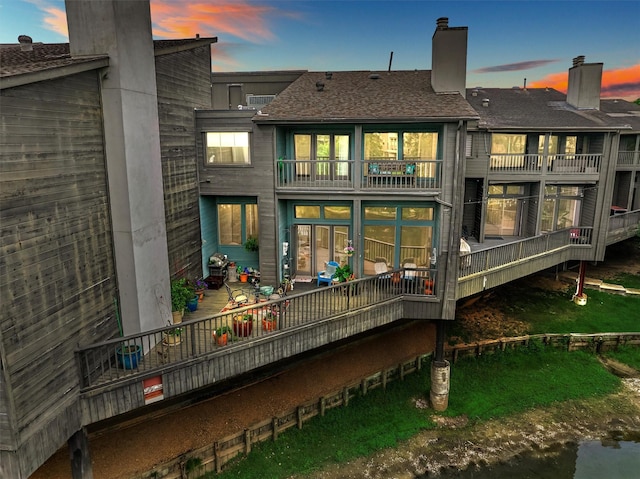 8800 Woodway Dr Unit 12, Houston, TX 77063 - back of house at dusk with a balcony and a chimney