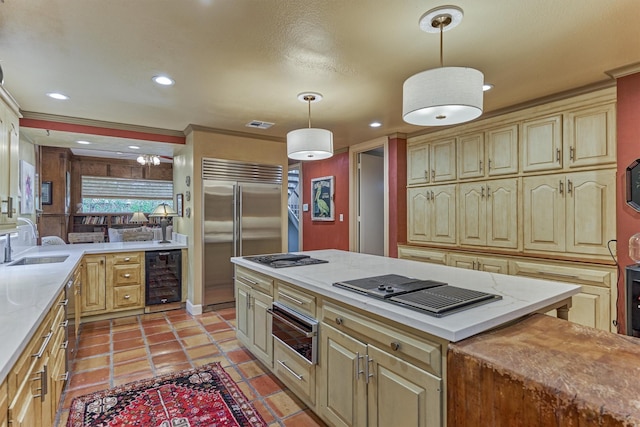 8800 Woodway Dr Unit 12, Houston, TX 77063 - kitchen with beverage cooler, a sink, built in fridge, a warming drawer, and stovetop with downdraft