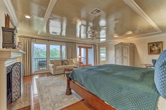 8800 Woodway Dr Unit 12, Houston, TX 77063 - bedroom with ornamental molding, multiple windows, access to exterior, a premium fireplace, and wood finished floors