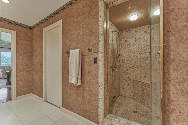 8800 Woodway Dr Unit 12, Houston, TX 77063 - bathroom featuring a shower stall, tile patterned flooring, and baseboards