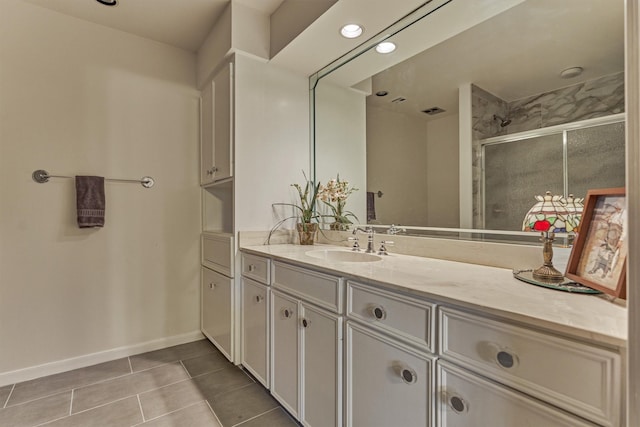 8800 Woodway Dr Unit 12, Houston, TX 77063 - bathroom featuring tile patterned floors, vanity, baseboards, and an enclosed shower
