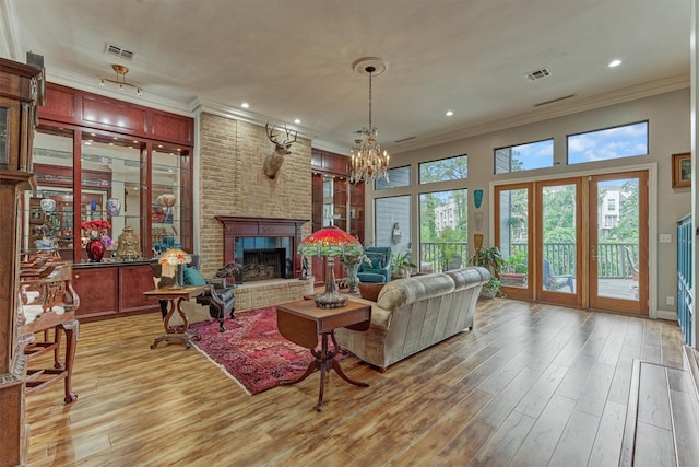 8800 Woodway Dr Unit 12, Houston, TX 77063 - living area featuring crown molding, a brick fireplace, light wood-style floors, a chandelier, and recessed lighting