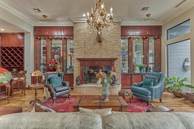 8800 Woodway Dr Unit 12, Houston, TX 77063 - living area with wood finished floors, ornamental molding, a chandelier, and a brick fireplace