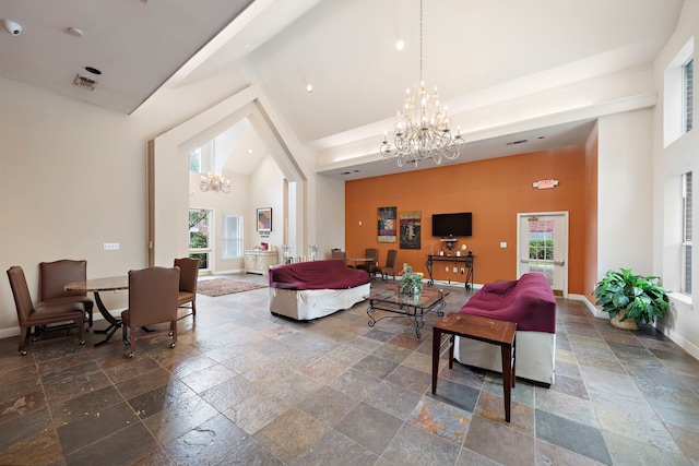 1330 Old Spanish Trl Unit 5203, Houston, TX 77054 - living room with stone tile flooring, a chandelier, high vaulted ceiling, plenty of natural light, and baseboards