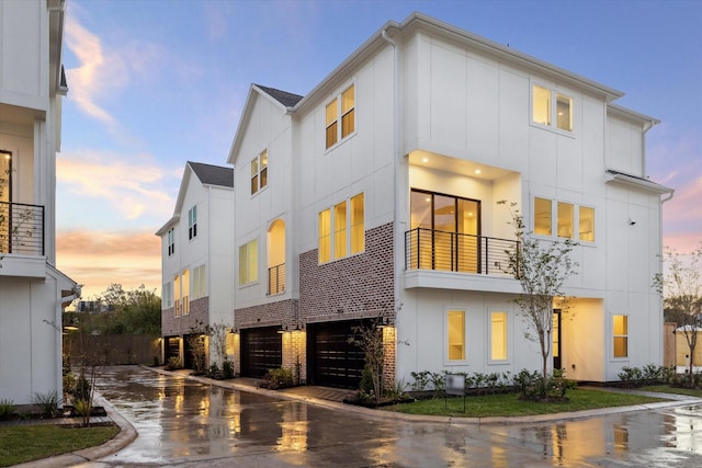 3049 Hicks St, Houston, TX 77007 - view of front of home with a garage, driveway, and board and batten siding