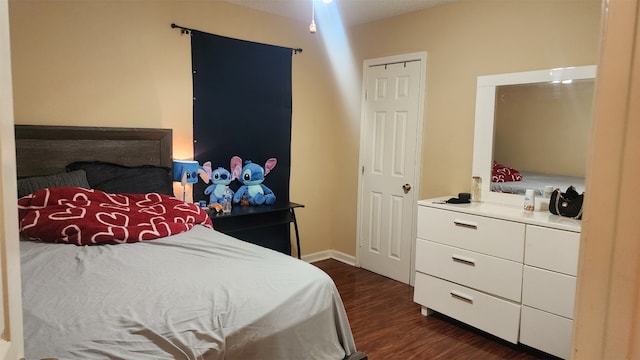 631 Soft Shadows Ln, Houston, TX 77013 - bedroom with dark wood-style floors and baseboards