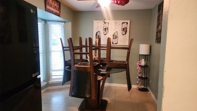 631 Soft Shadows Ln, Houston, TX 77013 - tiled dining room with ceiling fan, plenty of natural light, baseboards, and a textured ceiling