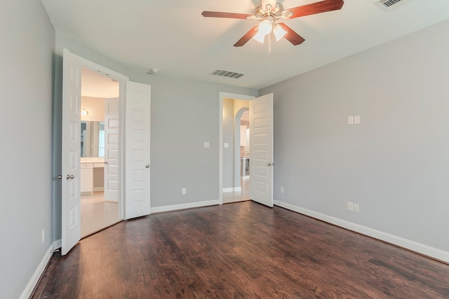13516 Northline Lake Dr, Houston, TX 77044 - unfurnished bedroom featuring arched walkways, wood finished floors, baseboards, and ensuite bath