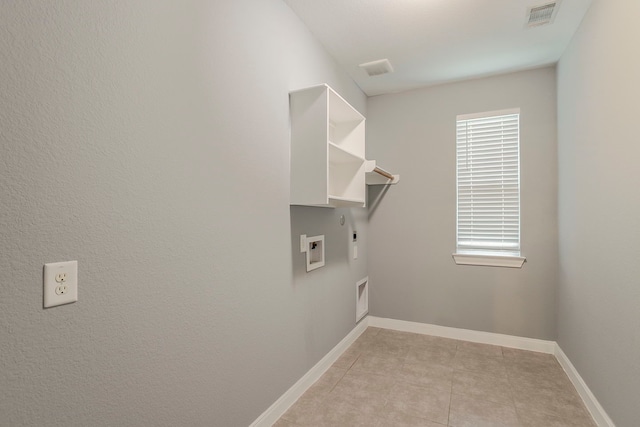 13516 Northline Lake Dr, Houston, TX 77044 - washroom with hookup for an electric dryer, gas dryer hookup, washer hookup, light tile patterned flooring, and baseboards