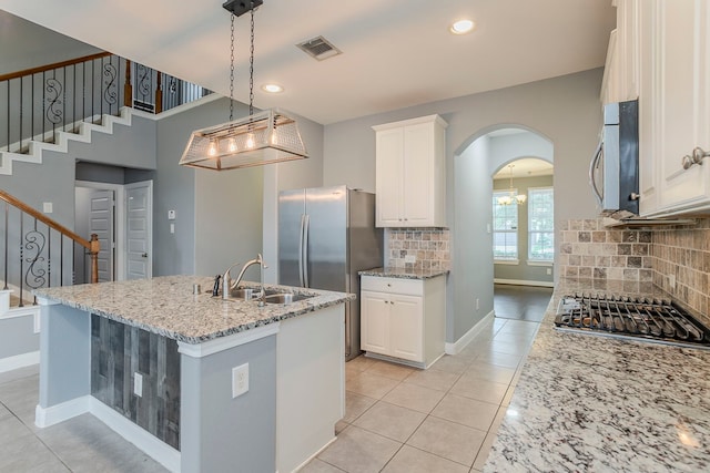 13516 Northline Lake Dr, Houston, TX 77044 - kitchen featuring stainless steel appliances, a sink, light stone counters, white cabinets, and light tile patterned flooring