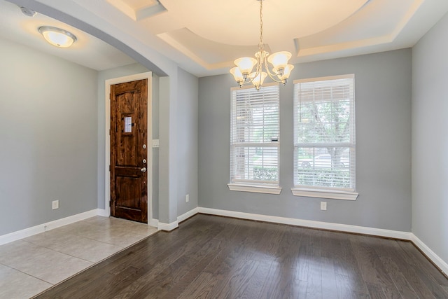 13516 Northline Lake Dr, Houston, TX 77044 - foyer featuring a chandelier, wood finished floors, baseboards, and a tray ceiling