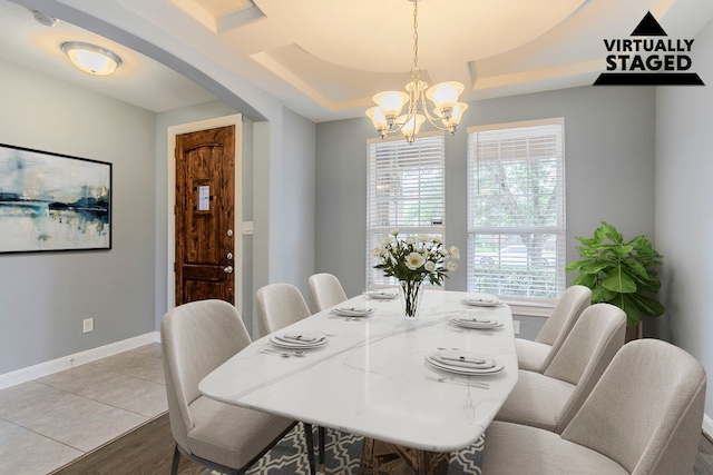 13516 Northline Lake Dr, Houston, TX 77044 - dining room with a chandelier, baseboards, light wood-style floors, and a raised ceiling