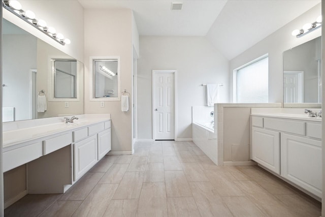 11318 Fawn Springs Ct, Cypress, TX 77433 - full bathroom featuring lofted ceiling, a garden tub, and two vanities