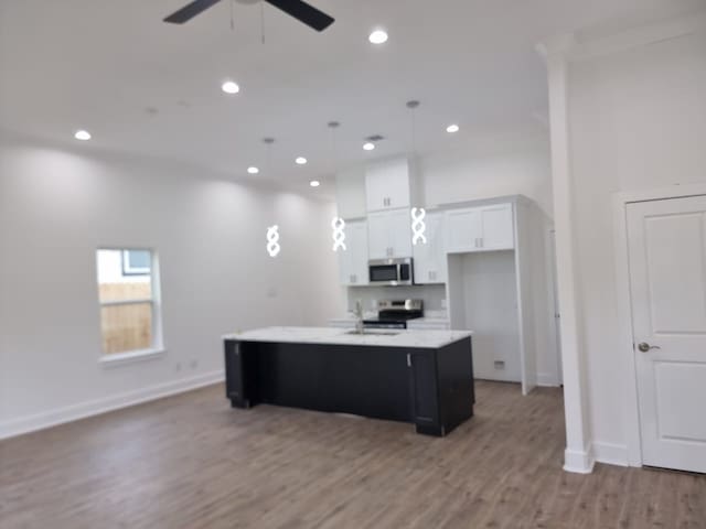 4539 Rosemont St A/B, Unit A/B Houston, TX 77051 - kitchen with stainless steel appliances, a ceiling fan, baseboards, white cabinets, and recessed lighting